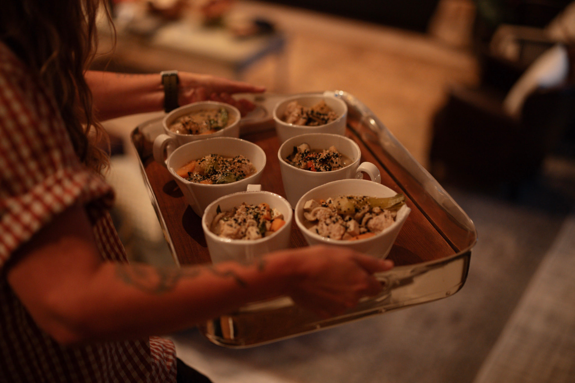 A tray of small bowls of warm food carried through the house