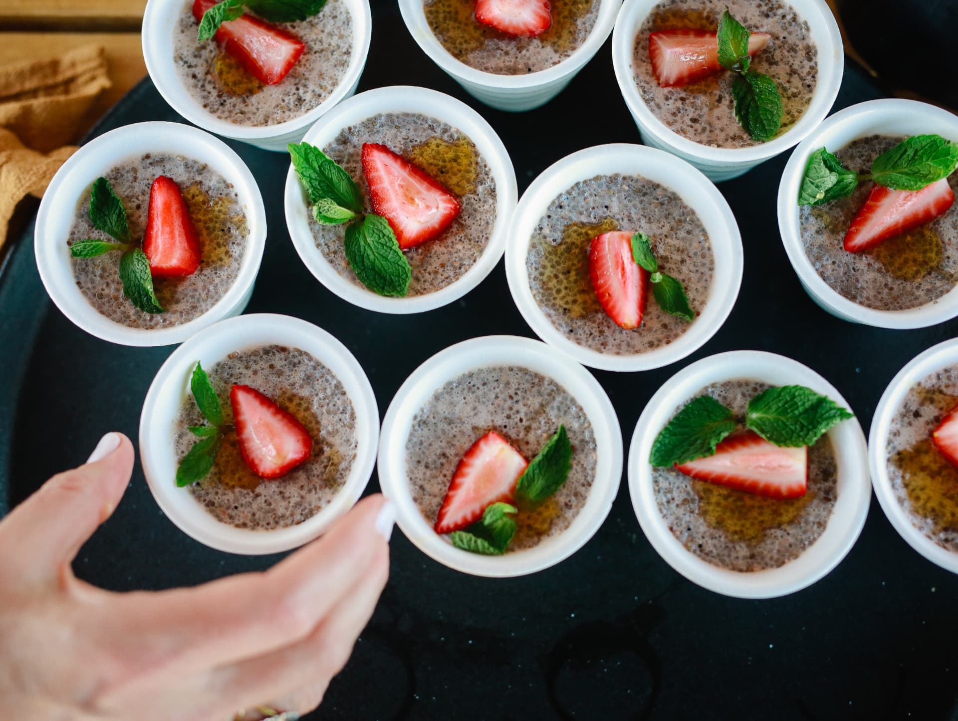 Overhead view of small desserts topped with strawberry and mint