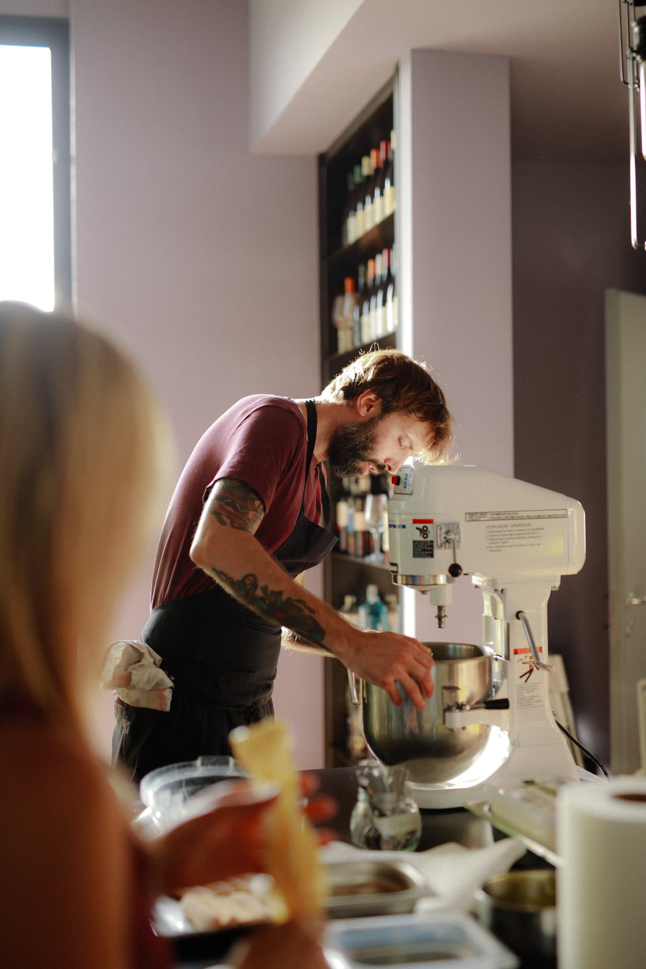 A chef preparing tiramisu at a stand mixer during the Italian cooking class