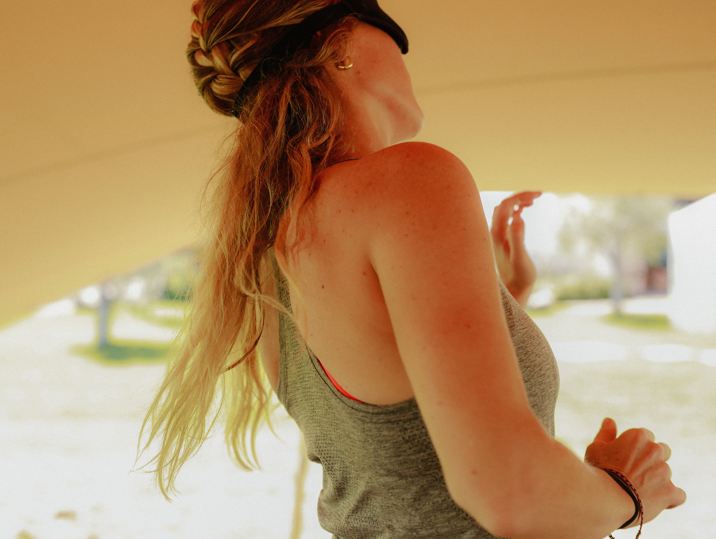 A woman with eyes closed moving in sunlight