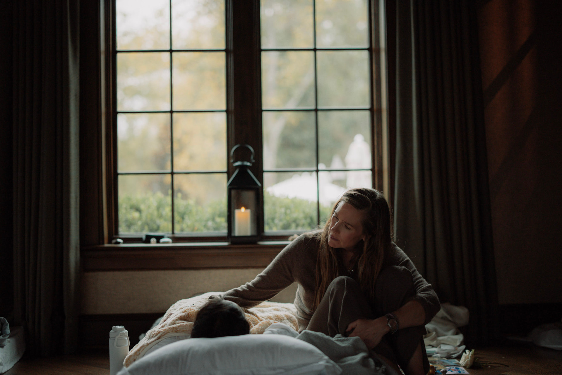 Lindsay offering quiet support beside a woman resting by the window